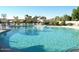 Large community pool with clear water, lounge chairs, and tropical landscaping at 10499 E Fanfol Ln, Scottsdale, AZ 85258