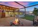 Backyard features a cozy fire pit, putting green, a covered patio, and an enclosed porch; perfect for entertaining at 10743 W Frier Dr, Glendale, AZ 85307