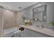 Well-lit bathroom with a tiled shower/tub combo and a vanity with ample counter space at 10743 W Frier Dr, Glendale, AZ 85307
