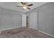 The primary bedroom with a ceiling fan and closet offers a peaceful retreat at 10743 W Frier Dr, Glendale, AZ 85307