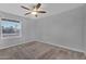 Inviting bedroom with a large window, ceiling fan, and cozy carpeting for a comfortable retreat at 10743 W Frier Dr, Glendale, AZ 85307