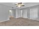 Spacious bedroom with carpeted floors, ceiling fan, and closet at 10743 W Frier Dr, Glendale, AZ 85307