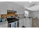 Bright kitchen features stainless steel appliances, white cabinets, and modern countertops at 10743 W Frier Dr, Glendale, AZ 85307