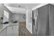 Modern kitchen with stainless steel refrigerator and views to the dining area at 10743 W Frier Dr, Glendale, AZ 85307