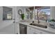 Bright kitchen with white cabinets and a view to the backyard covered patio at 10743 W Frier Dr, Glendale, AZ 85307