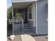 Inviting gray home entrance features white railings and steps at 11411 N 91St Ave # 75, Peoria, AZ 85345