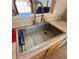 Close-up of a stainless steel kitchen sink with a modern faucet and a view to the backyard at 1612 E Barbarita Ave, Gilbert, AZ 85234