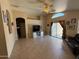 Bright living room featuring tile floors, ceiling fan, and sliding glass doors to the backyard at 1612 E Barbarita Ave, Gilbert, AZ 85234