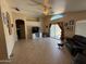 Bright living room with ceiling fan, vaulted ceilings, and sliding glass doors to the backyard at 1612 E Barbarita Ave, Gilbert, AZ 85234