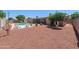 Large backyard with a swimming pool, covered patio, and desert landscaping at 1744 E Huber St, Mesa, AZ 85203
