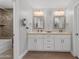 Elegant bathroom featuring a double vanity, modern fixtures, and a walk-in shower at 1744 E Huber St, Mesa, AZ 85203