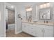 Bright bathroom featuring a double vanity, stylish mirrors, and modern lighting at 1744 E Huber St, Mesa, AZ 85203