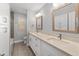 Bright bathroom featuring double sink vanity, decorative mirrors, and updated fixtures at 1744 E Huber St, Mesa, AZ 85203