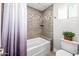 Bright bathroom featuring tiled shower-tub, decorative accents, and natural light at 1744 E Huber St, Mesa, AZ 85203
