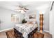 Cozy bedroom with ceiling fan, paris theme bedding, and window views at 1744 E Huber St, Mesa, AZ 85203