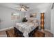 Cozy bedroom with a window view, a decorative rug, and a modern floor lamp at 1744 E Huber St, Mesa, AZ 85203