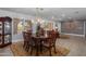 Bright dining space featuring chandelier and open layout concept connecting to the living area at 1744 E Huber St, Mesa, AZ 85203