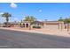 Inviting single-story home with a two-car garage, complemented by desert landscaping and a well-maintained lawn at 1744 E Huber St, Mesa, AZ 85203