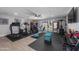Spacious home gym featuring modern exercise equipment, natural light, and a ceiling fan at 1744 E Huber St, Mesa, AZ 85203