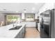 Bright kitchen boasts a marble island, stainless steel appliances, and modern white cabinetry at 1744 E Huber St, Mesa, AZ 85203