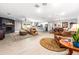 Spacious living room with fireplace, comfortable seating, and an open floor plan flowing into the kitchen at 1744 E Huber St, Mesa, AZ 85203