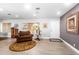 Inviting living room showcases a cozy armchair, a decorative rug, and ample natural light at 1744 E Huber St, Mesa, AZ 85203