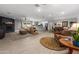 Spacious living room featuring a fireplace, modern lighting, and an open floor plan leading to the kitchen and dining area at 1744 E Huber St, Mesa, AZ 85203