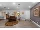 Cozy sitting area features a comfortable armchair, stylish rug, and natural light at 1744 E Huber St, Mesa, AZ 85203