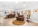 Open-concept living room with wood floors, a round accent rug and plenty of natural light at 1744 E Huber St, Mesa, AZ 85203