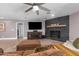 Inviting living room with large-screen TV, sleek stone fireplace, and comfortable seating at 1744 E Huber St, Mesa, AZ 85203