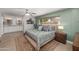 Comfortable main bedroom with a ceiling fan, ensuite bathroom with double sinks, and a view of the front yard at 1744 E Huber St, Mesa, AZ 85203