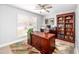 Dedicated home office with a large desk, bookcase, and bright windows at 1744 E Huber St, Mesa, AZ 85203