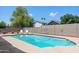 Backyard pool with desert landscaping and privacy fencing at 1744 E Huber St, Mesa, AZ 85203