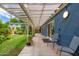 Covered patio with seating overlooking a lush backyard featuring a detached building and garden at 2219 W Catalina Dr, Phoenix, AZ 85015