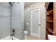 Stylish bathroom features tiled shower, modern fixtures, and a built-in wood cabinet at 2219 W Catalina Dr, Phoenix, AZ 85015