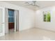 Spacious bedroom with neutral walls, tile flooring, and a door leading to a private area at 2219 W Catalina Dr, Phoenix, AZ 85015