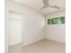 Bright bedroom featuring neutral walls, a ceiling fan, and an open closet space with storage at 2219 W Catalina Dr, Phoenix, AZ 85015