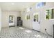 Bonus room with patterned floors, lots of natural light, utility shelving, and easy access to the backyard at 2219 W Catalina Dr, Phoenix, AZ 85015