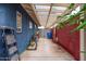 Exterior storage space featuring concrete floor, open roof, blue wall, and brick red wall at 2219 W Catalina Dr, Phoenix, AZ 85015