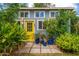 Charming home featuring a bright yellow front door, lush greenery and a serene, inviting entrance at 2219 W Catalina Dr, Phoenix, AZ 85015
