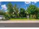 Charming single-story home with mature trees, lush landscaping, and well-maintained lawn at 2219 W Catalina Dr, Phoenix, AZ 85015