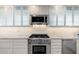 Bright kitchen featuring modern gas range, granite countertops, and white cabinets at 2219 W Catalina Dr, Phoenix, AZ 85015