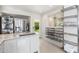 Bright kitchen with stainless steel appliances, granite counters, and open shelving for ample storage at 2219 W Catalina Dr, Phoenix, AZ 85015