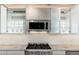 Modern kitchen with stainless steel microwave and gas range under bright cabinets at 2219 W Catalina Dr, Phoenix, AZ 85015