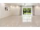 Bright living room featuring polished tile floor and sliding glass doors to backyard at 2219 W Catalina Dr, Phoenix, AZ 85015