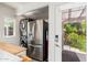 Mud room featuring a washer, dryer, refrigerator, vacuum and entry to backyard at 2219 W Catalina Dr, Phoenix, AZ 85015