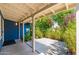Covered patio with lush landscaping and dark blue exterior at 2219 W Catalina Dr, Phoenix, AZ 85015