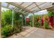 Covered patio with lush landscape, greenery, and beautiful outdoor lighting at 2219 W Catalina Dr, Phoenix, AZ 85015