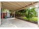 Exterior shot of a covered patio with concrete pad leading to a lush garden at 2219 W Catalina Dr, Phoenix, AZ 85015
