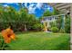 Charming backyard shed with bright yellow door, several windows, with landscaping at 2219 W Catalina Dr, Phoenix, AZ 85015